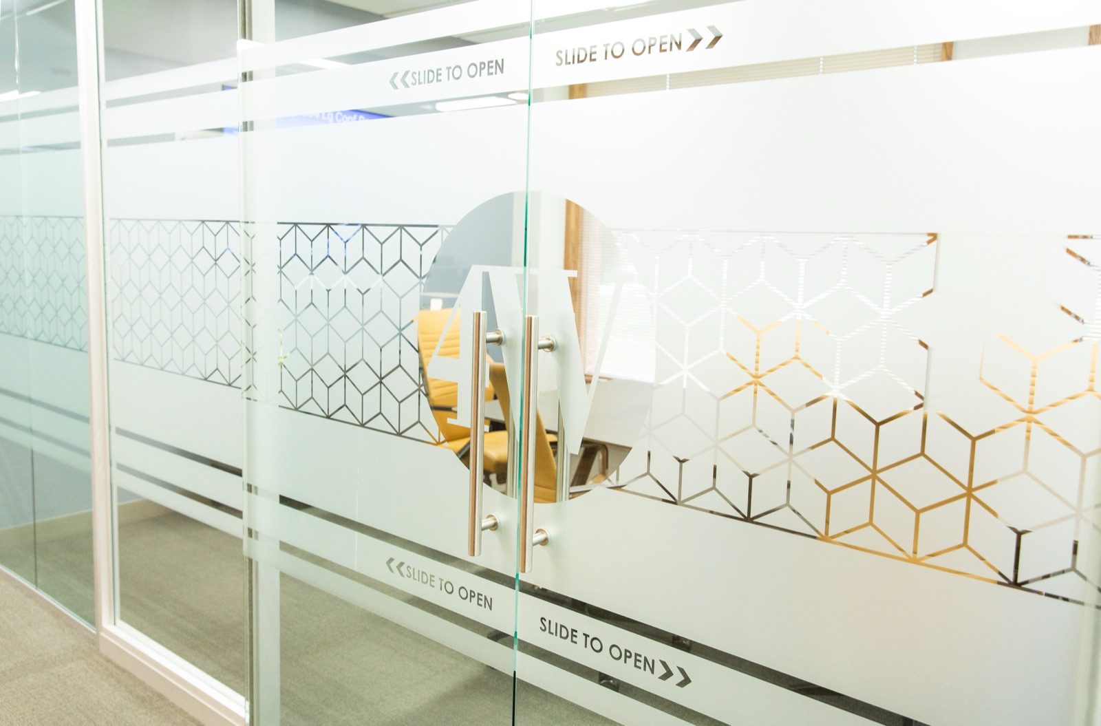 The 4Wealth office — etched glass doors with the 4W mark