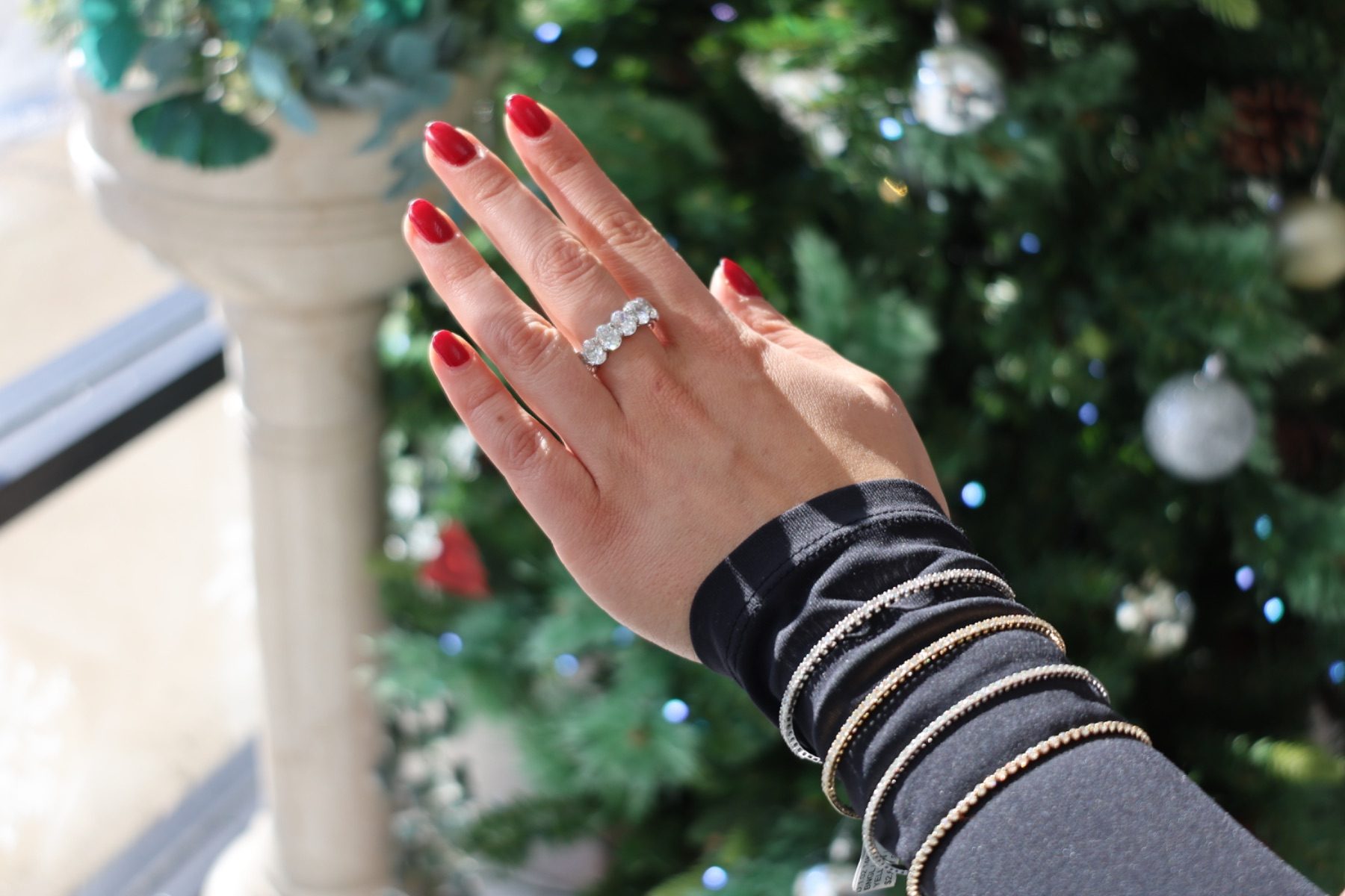 Diamond rings and bangles photographed against a holiday window display