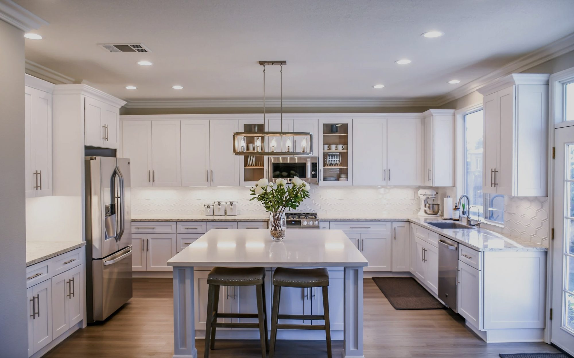 Peggy Smego — bright white kitchen with a marble island